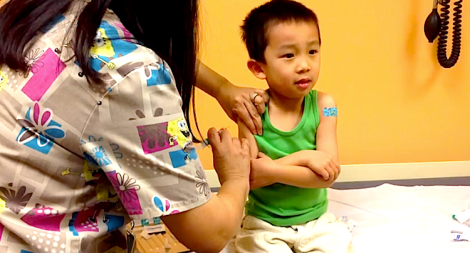 A toddle receives his five-year vaccination shots